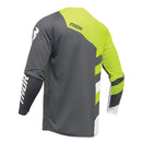 A long-sleeve motocross jersey from the THOR MX Sector Collection with a dynamic design in lime green, white, gray, and black. It features bold "THOR" text across the chest, additional graphic elements, and "SECTOR" on the lower side. A helmet graphic is depicted on the shoulder for top racewear style. This is the THOR SECTOR CHECKER JERSEY YOUTH GY/AC.