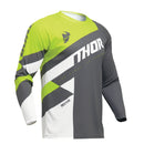 A long-sleeve motocross jersey from the THOR MX Sector Collection with a dynamic design in lime green, white, gray, and black. It features bold "THOR" text across the chest, additional graphic elements, and "SECTOR" on the lower side. A helmet graphic is depicted on the shoulder for top racewear style. This is the THOR SECTOR CHECKER JERSEY YOUTH GY/AC.