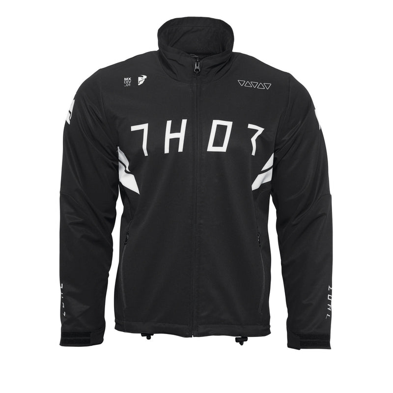 Introducing the THOR WARMUP JACKET BLACK/WHITE by THOR MX: This athletic black jacket features a zippered front, a high collar, and prominently displays the word “THOR” in bold white block letters across the chest. The sleeves boast white accents along with additional text. As part of the Warm Up collection, this jacket also includes practical front pockets and small logos near the collar and shoulders.