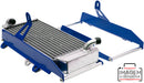 The image features a metal radiator assembly equipped with CrossPro blue mounting brackets. The radiator boasts a silver core with black fittings on one side, while an additional detached blue bracket is placed to the right of the unit. The image includes a watermark reading "IMAGEM ILUSTRATIVA." Notably, it showcases the RADIATOR BRACE CROSSPRO BLUE YAMAHA WR450F 12-15 for enhanced protection.
