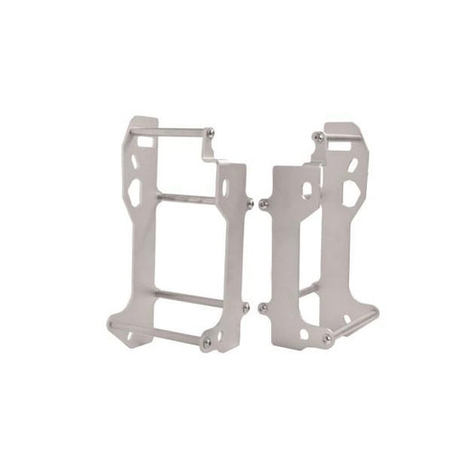 Two silver metal brackets stand upright, each featuring a rectangular frame with several cutouts and holes for mounting purposes. These *RADIATOR BRACE CROSSPRO SILVER SUZUKI RMZ250 10-18 appear designed for supporting or securing equipment, making them ideal for Suzuki RM-Z 250 radiator protection.