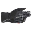 The Alpinestars Bogota Drystar XF Gloves by ALPINESTARS are black motorcycle gloves featuring protective armor and a ribbed backhand design. They offer waterproof performance with reinforced knuckles, a small red wrist accent, and the stylish Alpinestars logo on the cuff.