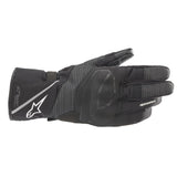 The Alpinestars Andes v3 Drystar Gloves, in black and dark gray with white branding, are made from goat leather for excellent grip. They feature reinforced sections for protection and are touch-screen compatible, offering durability and a perfect mix of style and functionality.