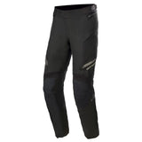 The Alpinestars Road Tech Gore-Tex Pants by Crown Kiwi Enterprises Limited are showcased against a white background. These black motorcycle pants boast ultimate abrasion resistance with GORE-TEX material, reinforced knee padding, zippered pockets, and subtle branding on the thigh—perfect for adventure touring enthusiasts.