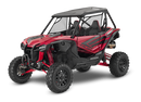 A red Honda Talon R off-road vehicle is pictured. It features robust, large tires, a roll cage, and sporty accents. The vehicle has a rugged design suitable for rough terrain, with visible shock absorbers and a roof for protection—perfect for sport side-by-side enthusiasts.