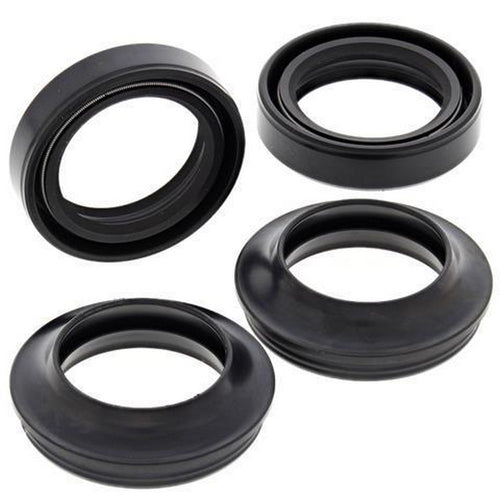 Four black seals from the FORK DUST & OIL SEAL PAIR by VERTEX are arranged on a white background. These rubber gaskets vary in size, with circular shapes featuring different inner diameters and thicknesses, similar to parts from the kit. The seals seem to be intended for mechanical or plumbing applications.