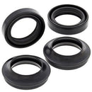 Four black seals from the FORK DUST & OIL SEAL PAIR by VERTEX are arranged on a white background. These rubber gaskets vary in size, with circular shapes featuring different inner diameters and thicknesses, similar to parts from the kit. The seals seem to be intended for mechanical or plumbing applications.