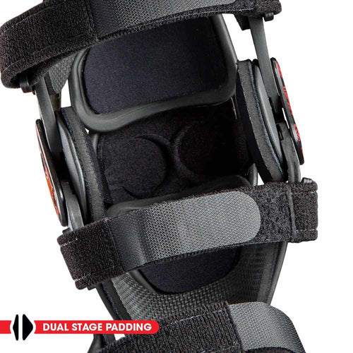 A pair of black KNEE BRACES ASTERISK JUNIOR CELL FOR DIRTBIKE RIDERS with adjustable straps and padding for support and protection. Each brace features a skeletal design logo on the front, part of the ASTERISK Junior Cell knee protection system.