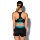 The ETHIKA WOMENS SUBZERO BLUE BLACK SPORTS BRA by Ethika is a black athletic sports bra with a racerback design. It features a wide blue elastic band at the bottom adorned with the "Ethika" logo printed in black. This low-impact bra is crafted from hyper-cooling fabric to ensure maximum comfort during workouts.