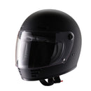 A black ELDORADO E70 RETRO DESIGN MATT BLACK helmet with a clear visor is shown on a white background. The full-face motorcycle helmet features ventilation slots at the top and front, boasting a solid, streamlined design. The visor is in a slightly raised position, revealing a padded interior and removable liner.