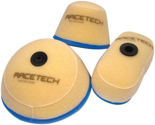 Three beige foam air filters with black central mounting points and blue bases, branded with "RTECH" in gray text. Designed for increased airflow, these RTECH AIR FILTERS are compatible with Kawasaki KX65 (2000-2021) and Suzuki RM65 (2003-2006), offering maximum protection across different motorsport or machinery applications.