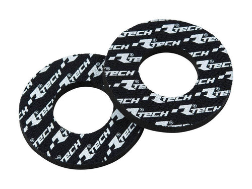 The HANDLEBAR GRIP DOUNT RTECH ANTI BLISTER grips, branded by RTECH, come in pairs and feature black foam construction with white "R TECH" logos. These grips have circular openings designed for easy installation on bicycle or motorcycle handlebars, providing enhanced grip and comfort.