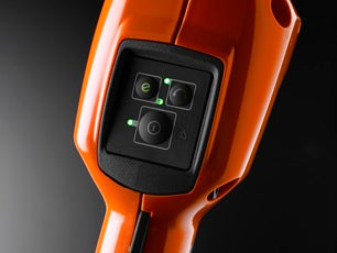 An image of a 2021 Husqvarna 520iLX Battery Grass Trimmer - Skin Only, featuring a head with a dual-line cutting system and an ergonomic handle. The motor and battery compartment are located at the rear end, showcasing its power and efficiency, with the device positioned horizontally against a plain white background.