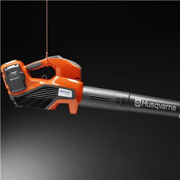 An orange and black Husqvarna 120iB Battery Blower Kit with a streamlined design. Ideal for the garden or forestry tasks, it has a large tubular nozzle and ergonomic handle, featuring the Husqvarna logo on the side of the nozzle.