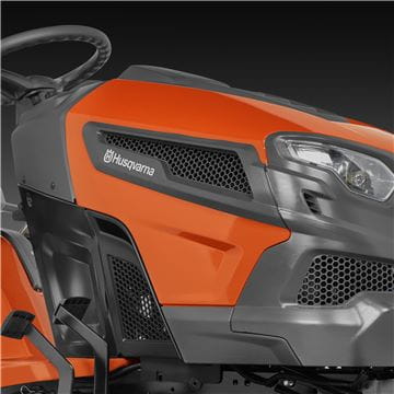 A Husqvarna TS242TXD Ride-On Mower is shown in bright orange, featuring a comfortable gray seat with armrests, large textured tires, and a robust ClearCut™ deck underneath. The side discharge tractor boasts a modern design with the prominent Husqvarna logo on its front.