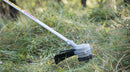 A red and silver gasoline-powered string trimmer/brush cutter with a long straight shaft, bicycle-style handles, and a black cutting head at the end. Experience similar performance to the Honda HHT36 Battery Brushcutter Kit from Honda Power Equipment for efficient yard maintenance.