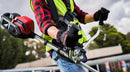 A red and silver gasoline-powered string trimmer/brush cutter with a long straight shaft, bicycle-style handles, and a black cutting head at the end. Experience similar performance to the Honda HHT36 Battery Brushcutter Kit from Honda Power Equipment for efficient yard maintenance.