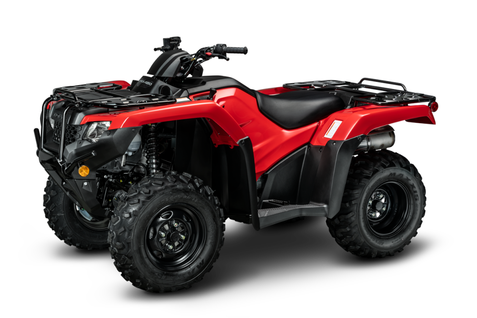The Honda TRX420FM2, an all-terrain vehicle (ATV) in a striking red color, boasts large, knobby tires and a sturdy suspension system. This ATV also features a black seat, handlebar with controls, cargo racks on both the front and rear ends, rugged fenders, and advanced Electronic Power Steering (EPS). Designed by Honda for off-road use, this vehicle is built to tackle challenging terrains with ease.