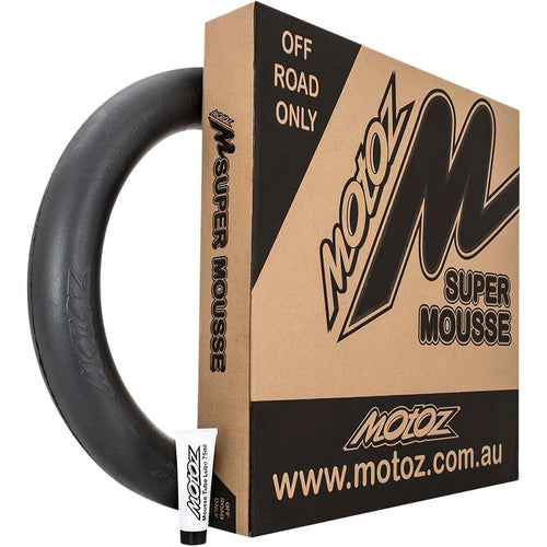 The product image features the MOTOZ Super Mousse Replaces Inner Tube to Prevent Punctures 140/80-18, specifically designed for off-road and enduro use. The mousse ring is positioned next to the brown product box, which displays black and white text and logos from the MOTOZ brand. In the bottom left corner, a small tube of lubricant is also visible. This product is ideal for MX adventures.
