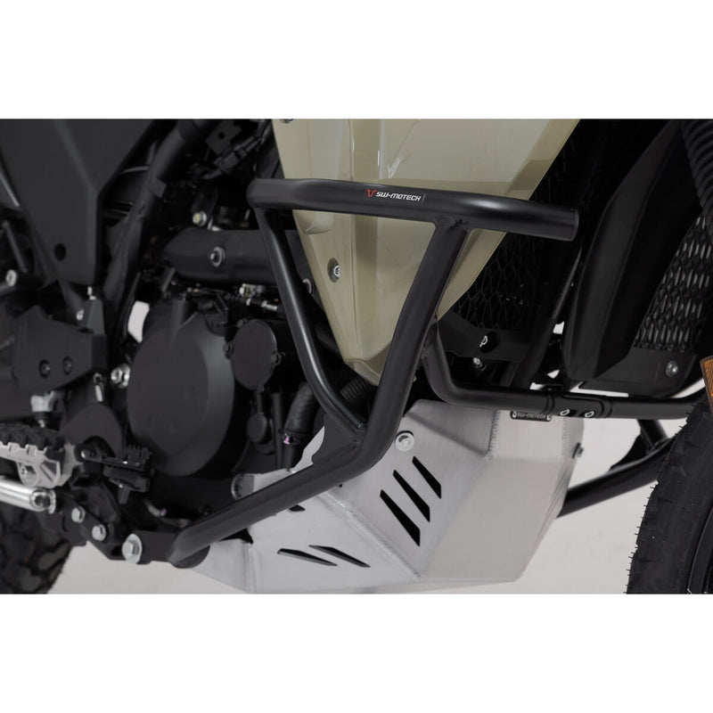 A close-up view of a Kawasaki KLR650 motorcycle featuring the CRASH BARS SW MOTECH KAWASAKI KLR650 22-23 by SW MOTECH. The image captures the front and side profile, showcasing the bike's beige and black color scheme, rugged tires, front suspension, engine guard, SW-MOTECH crash bars, and rear luggage rack against a plain white background.
