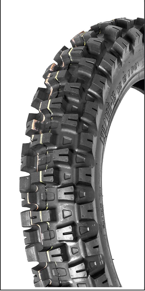 A close-up view of a 110 90 19 MOTOZ TYRE ARENA HYBRID - FOR ENDURO CROSS EXTREME ENDURO TECHNICAL CLOSED CIRCUIT EVENTS on an off-road motorcycle, showcasing its rugged tread pattern designed for optimal traction on diverse terrains. The tire features deep grooves and robust knobs for enhanced durability and performance, perfect for Extreme Enduro adventures.