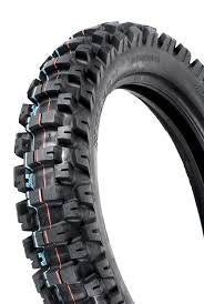 A black MOTOZ TYRE 110 100 18 TES (TRACTIONATOR ENDURO S/T) designed for aggressive traction on rough terrain. This off-road tire features deep, rugged treads with a pattern of large, blocky knobs around the circumference, providing exceptional grip and durability for off-road riding. The background is white.