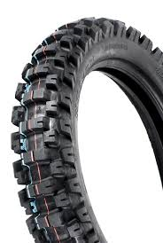 A black MOTOZ TYRE 110 100 18 TES (TRACTIONATOR ENDURO S/T) designed for aggressive traction on rough terrain. This off-road tire features deep, rugged treads with a pattern of large, blocky knobs around the circumference, providing exceptional grip and durability for off-road riding. The background is white.