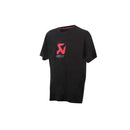The Akrapovic Logo Tee Black XL by AKRAPOVIC is made of 100% cotton and boasts a striking red logo with "Akrapovic" printed below on the front, providing both style and comfort against a plain white backdrop.