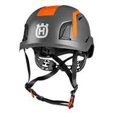 The Husqvarna Spire Arborist Helmet is a grey and orange helmet featuring a prominent "H" logo on the front. It is designed for professional arborists, equipped with black adjustable straps, a chin strap for secure fitting, and a Spire Vent system that ensures protection in various hazardous work environments.