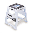 The MATRIX M64 Elite Stand White by Crown Kiwi Enterprises Limited is a lightweight stand ideal for motocross supercross fans. It features a square opening on top and showcases "Matrix M" branding on the sides. With reinforced legs for added stability, it's a dependable choice for off-road racing adventures.