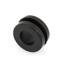 The Akrapovic Rubber Spacer Grommet by AKRAPOVIC is a black, circular rubber grommet with a central hole and circumferential groove, perfect for protecting or insulating openings. It is displayed against a crisp white background to highlight its detailed design.