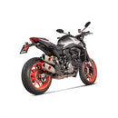 The Akrapovic Heat Shield Ducati Monster 937 by AKRAPOVIC is a black climbing hold with a marbled texture, three bolt holes, and an angular, asymmetrical shape reminiscent of a carbon-fibre heatshield's precision. It reflects the sleek design of a Ducati Monster against a plain white background.
