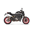The Akrapovic Heat Shield Ducati Monster 937 by AKRAPOVIC is a black climbing hold with a marbled texture, three bolt holes, and an angular, asymmetrical shape reminiscent of a carbon-fibre heatshield's precision. It reflects the sleek design of a Ducati Monster against a plain white background.