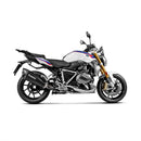 A sleek, black Akrapovic Slip On Muffler for the BMW R1250R/RS motorcycle features a dual-outlet design. The AKRAPOVIC branding logo is prominently displayed on the side of the exhaust. With metallic and carbon fiber elements and the signature Akrapovic sound, it boasts a modern and high-performance appearance.
