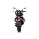 A sleek, black Akrapovic Slip On Muffler for the BMW R1250R/RS motorcycle features a dual-outlet design. The AKRAPOVIC branding logo is prominently displayed on the side of the exhaust. With metallic and carbon fiber elements and the signature Akrapovic sound, it boasts a modern and high-performance appearance.