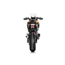 The Akrapovic Slip On BMW F900R/XR 2020-23 exhaust boasts a sleek metallic design with a rectangular carbon fiber-trimmed end, featuring a red logo on its black segment. Set diagonally against a white backdrop, it beautifully captures the signature AKRAPOVIC sound.