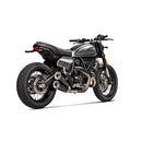 The Akrapovic Ducati Scrambler 2021-22 dual exhaust system, by AKRAPOVIC, features a sleek design with metallic pipes and black cans decorated with a logo. Made from stainless steel, the circular tips offer a polished and modern look.