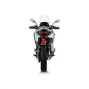 An Akrapovic Slip On Honda CRF1100L exhaust system in sleek silver against a white backdrop, featuring a black carbon fiber tip, titanium construction, and mounting bracket. Its modern aerodynamic design embodies the essence of "Durability Reimagined.