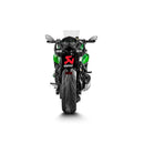 A close-up of the AKRAPOVIC Slip-On Muffler Z1000SX 20-23 showcases its carbon fiber finish. The streamlined design features metallic accents and the iconic yellow-red Akrapovic logo, enhancing its renowned sound, all isolated on a white background.