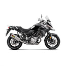 A sleek AKRAPOVIC Slip On V-Strom 650 17-23 with a silver metallic finish and carbon fiber tip features its logo on the curvy titanium muffler, set against a plain white background.