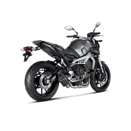 The Akrapovic Full System for Yamaha MT09/XSR900 by AKRAPOVIC is a racing exhaust with a sleek metallic finish, featuring multiple curved pipes leading to a black carbon fiber muffler adorned with a red and yellow logo.