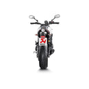 The Akrapovic Full System for Yamaha MT09/XSR900 by AKRAPOVIC is a racing exhaust with a sleek metallic finish, featuring multiple curved pipes leading to a black carbon fiber muffler adorned with a red and yellow logo.
