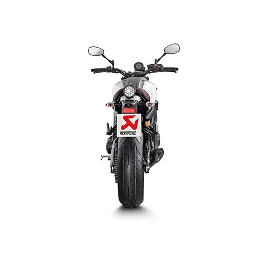 The Akrapovic Full System for Yamaha MT09/XSR900 by AKRAPOVIC is a racing exhaust with a sleek metallic finish, featuring multiple curved pipes leading to a black carbon fiber muffler adorned with a red and yellow logo.