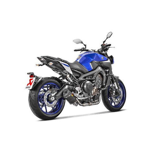 The Akrapovic Full System for Yamaha MT09/XSR900 by AKRAPOVIC is a racing exhaust with a sleek metallic finish, featuring multiple curved pipes leading to a black carbon fiber muffler adorned with a red and yellow logo.
